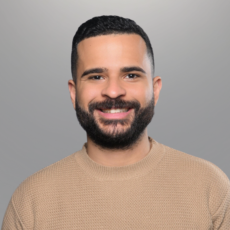 Man in tan shirt smiling