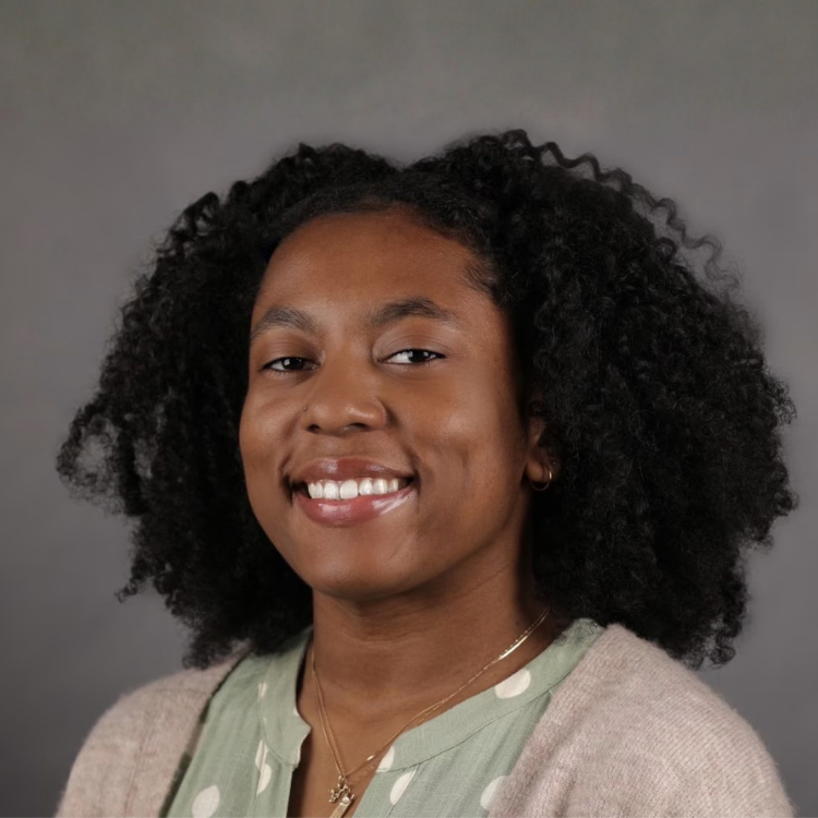 Woman in polka dot shirt smiling